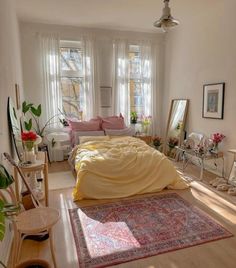 a bed sitting in a bedroom next to a window filled with lots of windows and furniture