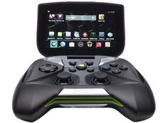 a close up of a game controller with a tablet in the background