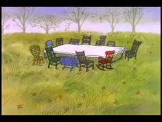 a table and chairs sitting in the middle of a field