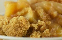 a close up of a plate of food with fruit on it and crumbs