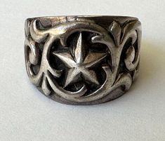 i love a good star ring, and this one is pretty spectacular.  it's sterling, with a fine five-pointed star surrounded by scrollwork.  the designs have nice relief, reasonable wear.  faintly marked 925. size:  8 height of face:  5/8" width of inner band:  3/16" weight:  6.2g Goth Staples, Alt Rings, October Jewelry, Chrome Hearts Jewelry, Vintage Sterling Silver Rings, Five Pointed Star, Fabric Accessories, Diy Rings, Funky Jewelry