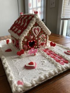 a cake shaped like a house with hearts on it