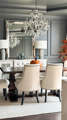 a dining room table with chairs and a chandelier