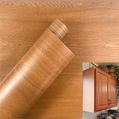 a kitchen with wooden cabinets and an image of a roll of wood