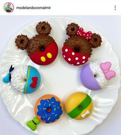 a white plate topped with different types of donuts