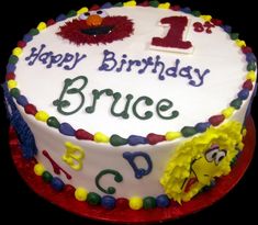 a birthday cake with the number one on it and sesame street characters in frosting