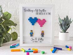 legos are arranged in front of a frame with the words building is life together, one brick at a time