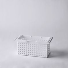 a white basket sitting on top of a table