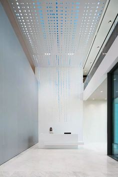 an empty room with a white bathtub and blue lights on the ceiling