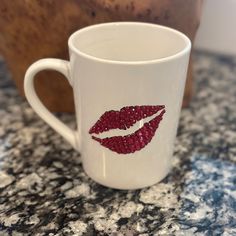 a white coffee cup with red lipstick on it