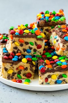 a white plate topped with pieces of cake covered in candy