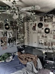 a bed room with a neatly made bed and lots of pictures on the wall