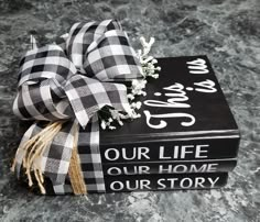 two black and white books tied to each other with a bow on top of them