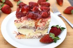 there is a piece of cake with strawberries on it