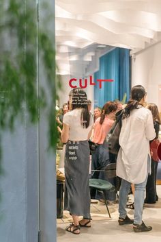 people are standing in front of a cut sign