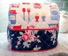 a close up of a bag on a counter with flowers and kitchen utensils