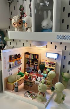 a room filled with toys and books on top of a shelf next to each other