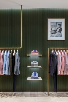 a clothing store with green walls and shelves filled with clothes