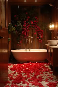 a bathtub with rose petals on the floor