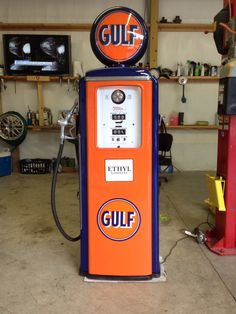 an orange and blue gas pump in a garage