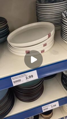 shelves with plates and bowls on them in a store