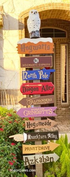 a wooden sign with many different colored signs on it's side in front of a brick building