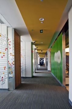 the hallway is lined with white and green wallpapers, along with many different colored dots