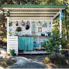 a small white shed with pots and pans on it