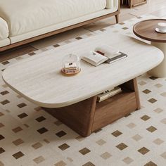 a coffee table sitting on top of a living room floor next to a white couch