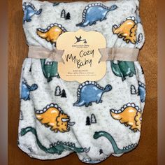 a baby bib with dinosaurs on it