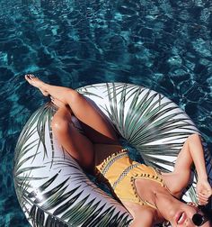 a woman laying on top of an inflatable float