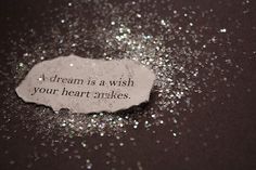 a piece of paper with the words dream is a wish your heart makes on it