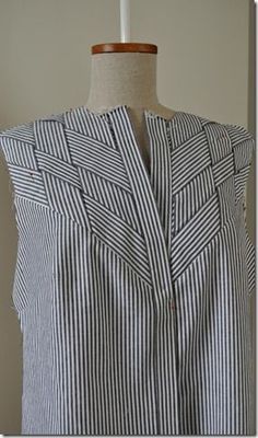 a woman's dress on a mannequin with a white and black striped shirt