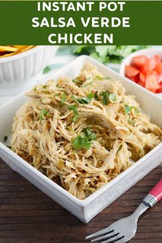 a white bowl filled with shredded chicken and garnished with cilantro