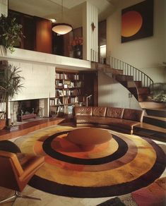 a living room filled with lots of furniture and a spiral rug on top of the floor