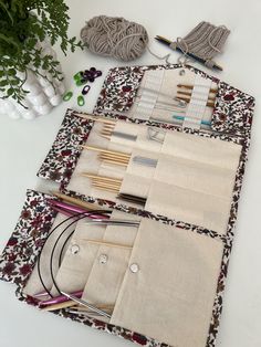 the table is covered with different types of knitting supplies