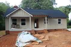 a house is being built in the middle of a construction area with dirt on the ground