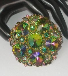 "Offering a Rare fabulous Juliana D & E Watermelon Rivoli Brooch.  This beautiful vintage brooch makes a statement and is a massive 3\".  There are six gorgeous Watermelon  Rivoli crystals accented with Olivine crystal florets, and clusters of round Emerald green and iridescent AB Crystals.  It is set in a gold metal and the craftsmanship is undeniably unmarked \"JULIANA\".   About Juliana D & E vintage jewelry:  The name \"Juliana\"is synonymous with jewelry made by DeLizza and Elster.  In the late 60s, Their magnificent designer jewelry pieces were originally marked only with paper hang tags.  This is one of those awesome pieces from their select group of savvy costume jewelry.  This is truly a collector's item and absolutely gorgeous!  The pictures don't really do it justice...It won't Juliana Jewelry Vintage, Juliana Jewelry, 1960s Dresses, 1960s Jewelry, Crystal Brooch, Vintage Brooch, Vintage Costume Jewelry, Vintage Jewellery, Hang Tags