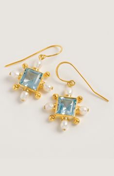 To celebrate Queen Elizabeth II’s platinum jubilee we've launched two exquisite Blue Topaz styles, one being these earrings, from our Regal 54 collection. Inspired by the frivolity and glamour of 1970s New York, the glittering energy of Studio 54, and the elaborate opulence of Tudor jewellery, the Regal 54 collection exudes divine femininity. More Details Handcrafted from 18ct gold plated sterling silver, Freshwater Pearls, and a statement Blue Topaz centre gemstone, the unique cross earrings ar 1970s New York, Platinum Jubilee, Studio 54, Rose Blue, Cross Earrings, Topaz Gemstone, Queen Elizabeth Ii, Elizabeth Ii, Signature Design