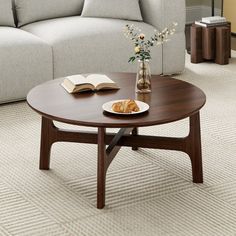 a coffee table with an open book on it