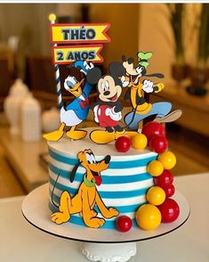 a mickey mouse birthday cake on a table