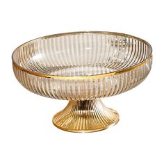 a clear glass bowl with gold trimmings on the rim and base, sitting on a white surface