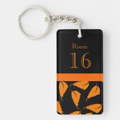 an orange and black keychain with the name room 16 on it is shown