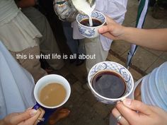 three people are holding coffee cups with the words, this is what life is all about