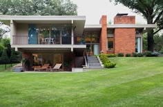 a large house sitting on top of a lush green field