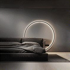 a bed sitting in a bedroom next to a round light