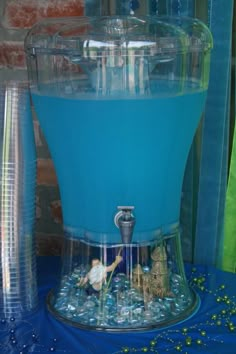 the blue liquid is being used as a water dispenser