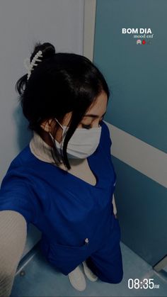 a woman wearing a face mask while sitting on a toilet