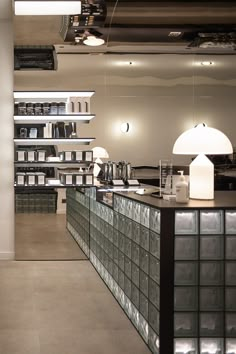 the interior of a coffee shop with lots of glass blocks on the counter and shelves