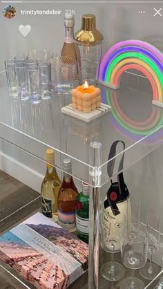 a clear table topped with lots of bottles and glasses